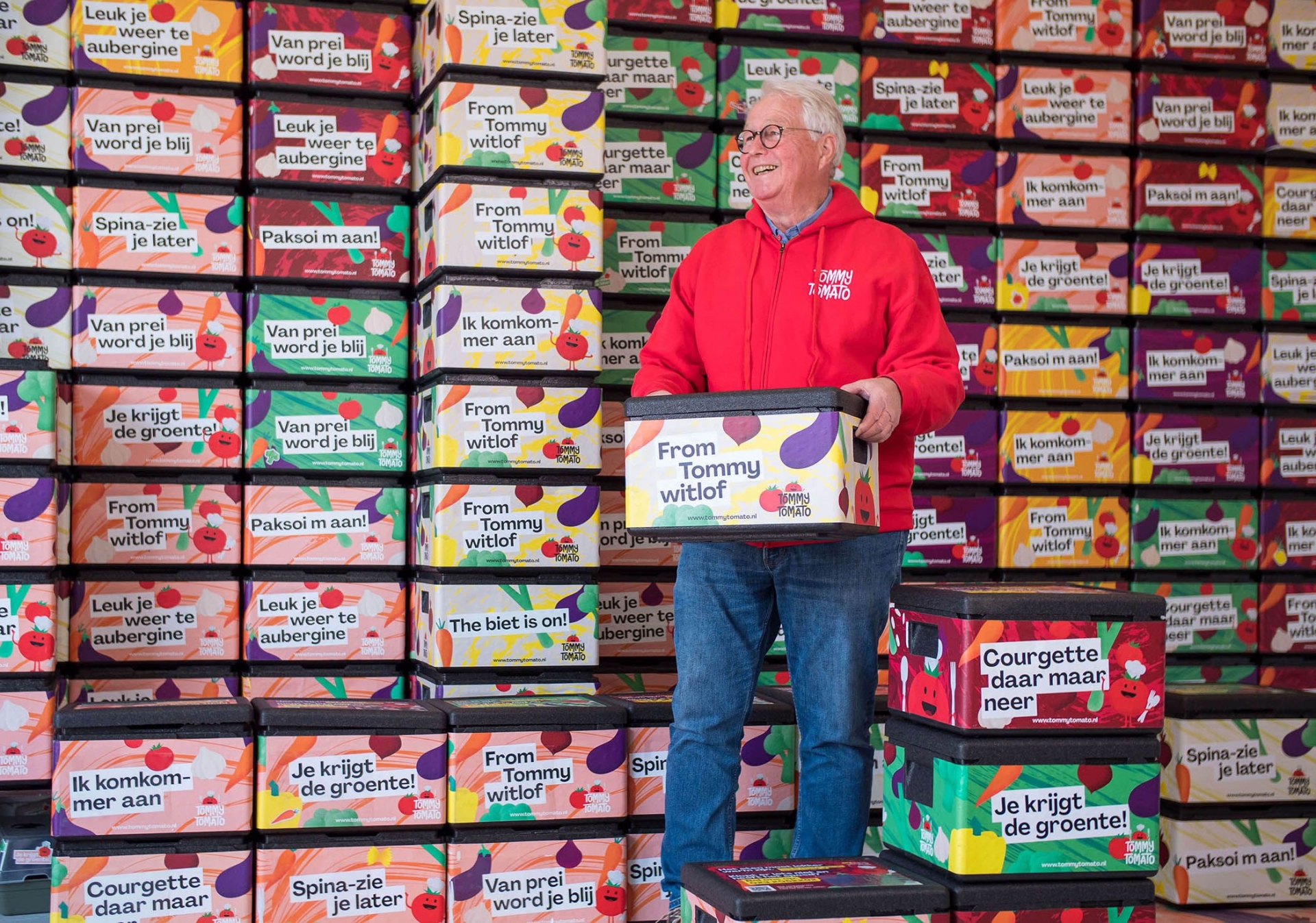 Tommy tomato medewerker in het voorraad magazijn met bezorgdozen