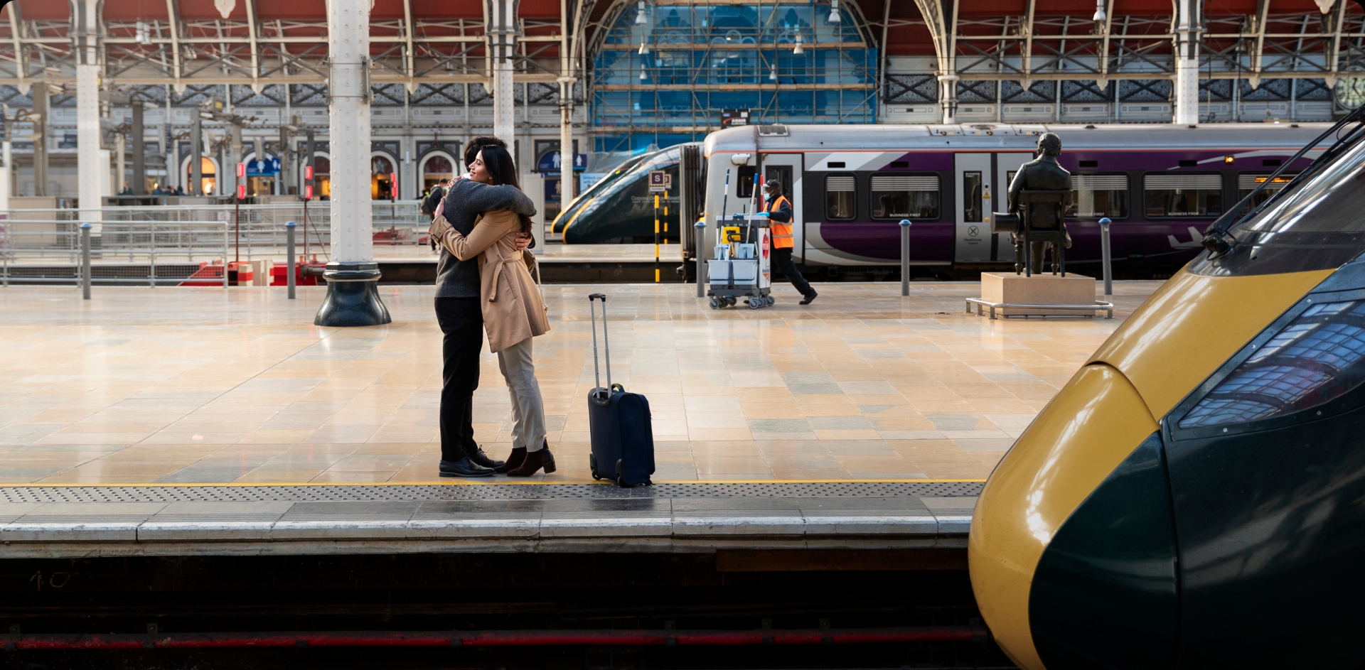 Two people hugging at the train station