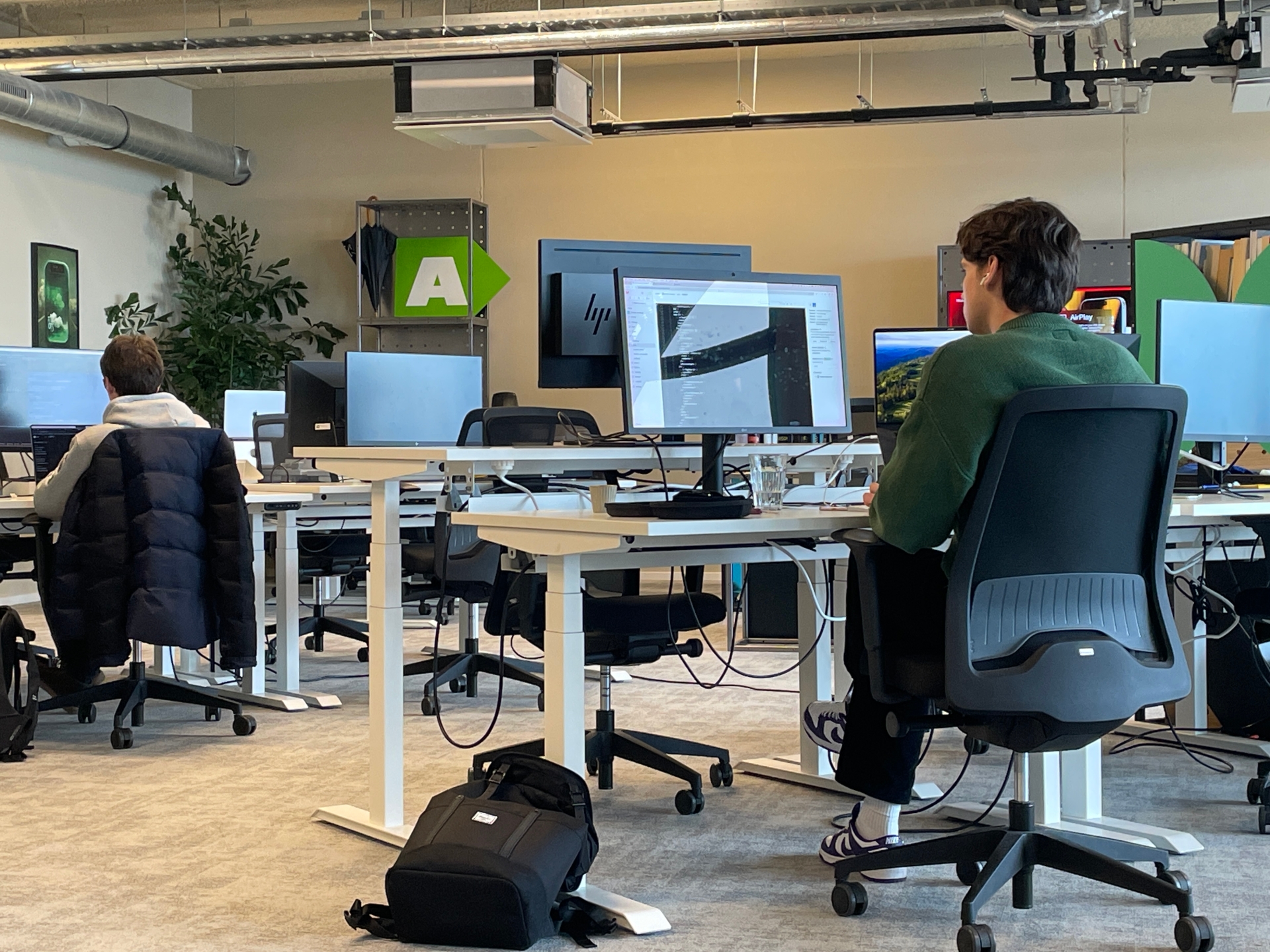 Two man sitting behind their computers